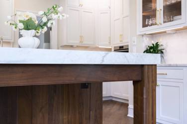 Two-tone kitchen with walnut island and white cabinetry in Cary, NC