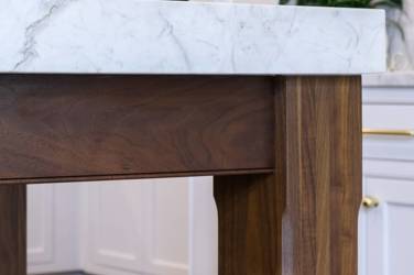 Two-tone kitchen with walnut island and white cabinetry in Cary, NC