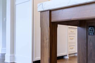 Two-tone kitchen with walnut island and white cabinetry in Cary, NC
