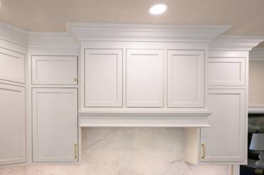 Two-tone kitchen with walnut island and white cabinetry in Cary, NC