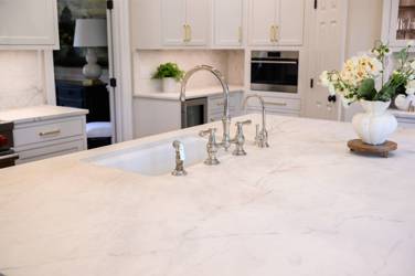Two-tone kitchen with walnut island and white cabinetry in Cary, NC