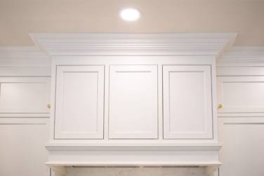 Two-tone kitchen with walnut island and white cabinetry in Cary, NC