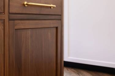 Two-tone kitchen with walnut island and white cabinetry in Cary, NC