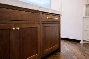 Two-tone kitchen with walnut island and white cabinetry in Cary, NC
