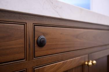 Two-tone kitchen with walnut island and white cabinetry in Cary, NC