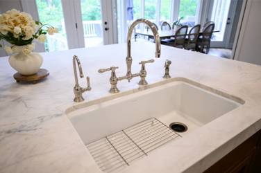 Two-tone kitchen with walnut island and white cabinetry in Cary, NC