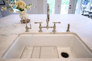 Two-tone kitchen with walnut island and white cabinetry in Cary, NC