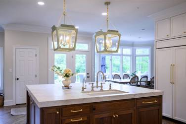 Two-tone kitchen with walnut island and white cabinetry in Cary, NC