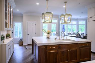 Two-tone kitchen with walnut island and white cabinetry in Cary, NC