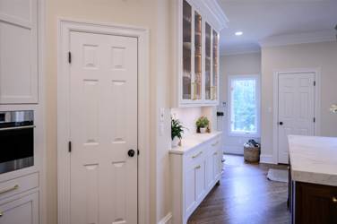 Two-tone kitchen with walnut island and white cabinetry in Cary, NC