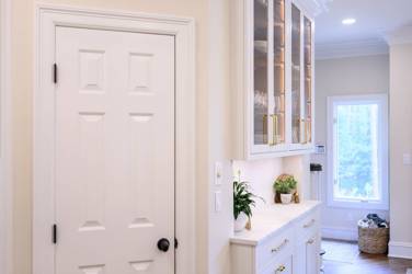 Two-tone kitchen with walnut island and white cabinetry in Cary, NC