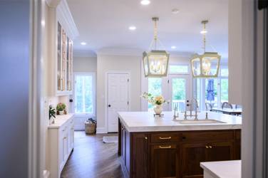 Two-tone kitchen with walnut island and white cabinetry in Cary, NC