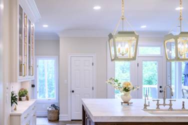 Two-tone kitchen with walnut island and white cabinetry in Cary, NC