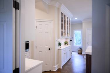 Two-tone kitchen with walnut island and white cabinetry in Cary, NC