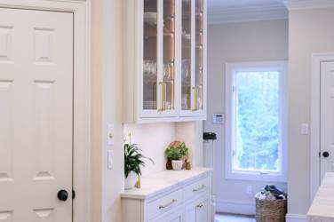 Two-tone kitchen with walnut island and white cabinetry in Cary, NC