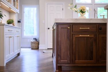 Two-tone kitchen with walnut island and white cabinetry in Cary, NC
