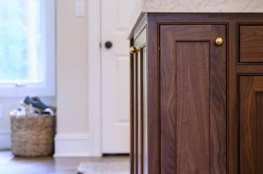 Two-tone kitchen with walnut island and white cabinetry in Cary, NC