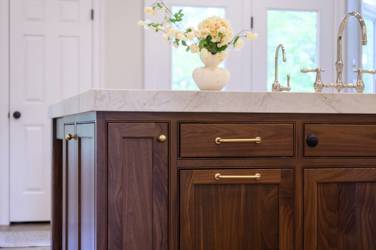 Two-tone kitchen with walnut island and white cabinetry in Cary, NC