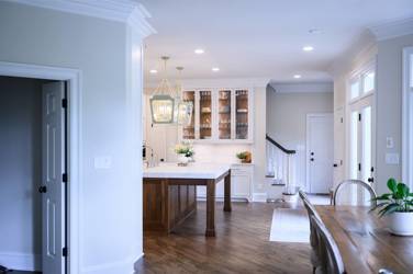 Two-tone kitchen with walnut island and white cabinetry in Cary, NC
