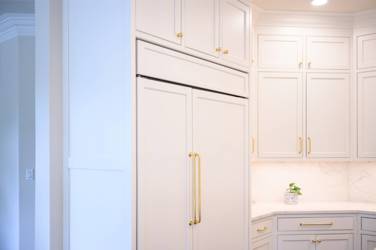 Two-tone kitchen with walnut island and white cabinetry in Cary, NC