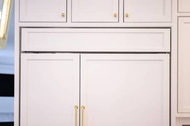 Two-tone kitchen with walnut island and white cabinetry in Cary, NC