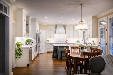 White kitchen with gray island and herringbone tile backsplash in Cary, NC