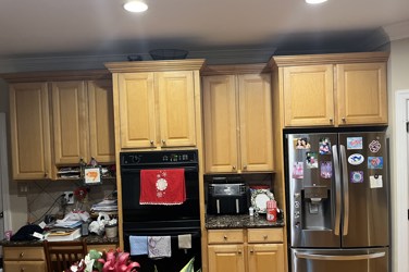 White kitchen with gray island and herringbone tile backsplash in Cary, NC