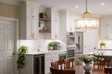 White kitchen with gray island and herringbone tile backsplash in Cary, NC