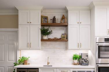 White kitchen with gray island and herringbone tile backsplash in Cary, NC