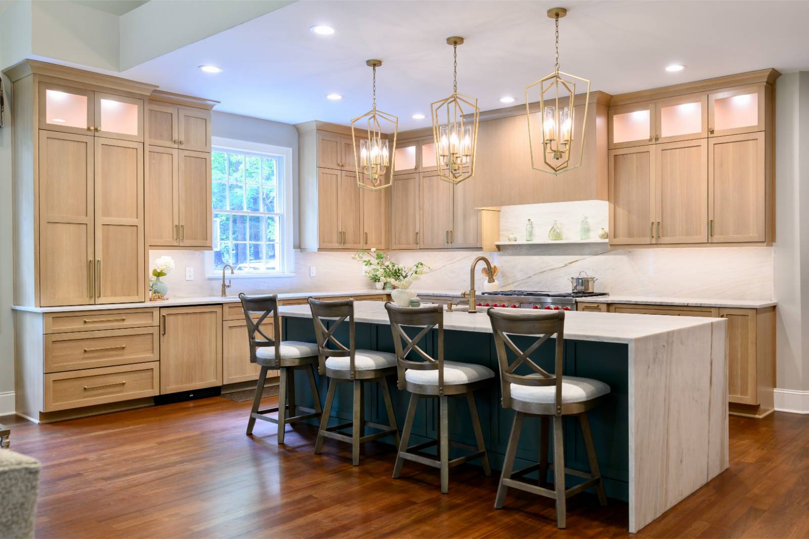 White oak kitchen with sage green island and white quartzite waterfall counters in Raleigh, NC