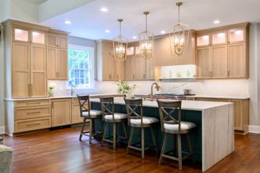 White oak kitchen with sage green island and white quartzite waterfall counters in Raleigh, NC