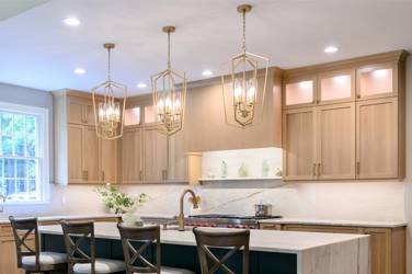 White oak kitchen with sage green island and white quartzite waterfall counters in Raleigh, NC