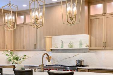 White oak kitchen with sage green island and white quartzite waterfall counters in Raleigh, NC