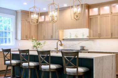 White oak kitchen with sage green island and white quartzite waterfall counters in Raleigh, NC