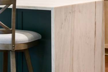White oak kitchen with sage green island and white quartzite waterfall counters in Raleigh, NC