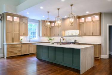White oak kitchen with sage green island and white quartzite waterfall counters in Raleigh, NC