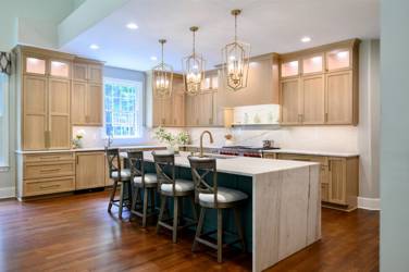 White oak kitchen with sage green island and white quartzite waterfall counters in Raleigh, NC
