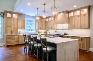 White oak kitchen with sage green island and white quartzite waterfall counters in Raleigh, NC