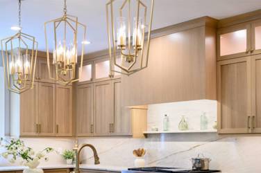 White oak kitchen with sage green island and white quartzite waterfall counters in Raleigh, NC