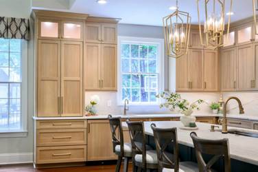 White oak kitchen with sage green island and white quartzite waterfall counters in Raleigh, NC