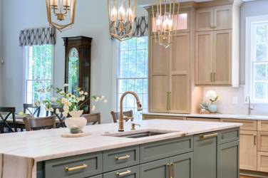 White oak kitchen with sage green island and white quartzite waterfall counters in Raleigh, NC