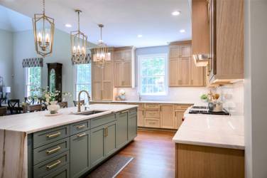 White oak kitchen with sage green island and white quartzite waterfall counters in Raleigh, NC