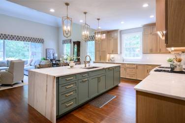 White oak kitchen with sage green island and white quartzite waterfall counters in Raleigh, NC