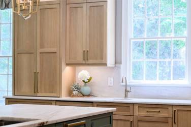 White oak kitchen with sage green island and white quartzite waterfall counters in Raleigh, NC