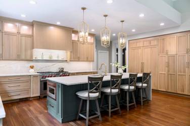 White oak kitchen with sage green island and white quartzite waterfall counters in Raleigh, NC
