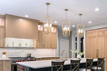 White oak kitchen with sage green island and white quartzite waterfall counters in Raleigh, NC