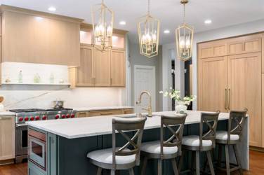 White oak kitchen with sage green island and white quartzite waterfall counters in Raleigh, NC