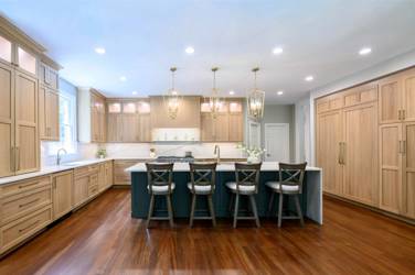 White oak kitchen with sage green island and white quartzite waterfall counters in Raleigh, NC