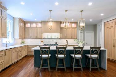White oak kitchen with sage green island and white quartzite waterfall counters in Raleigh, NC