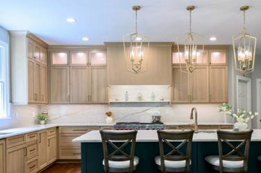 White oak kitchen with sage green island and white quartzite waterfall counters in Raleigh, NC